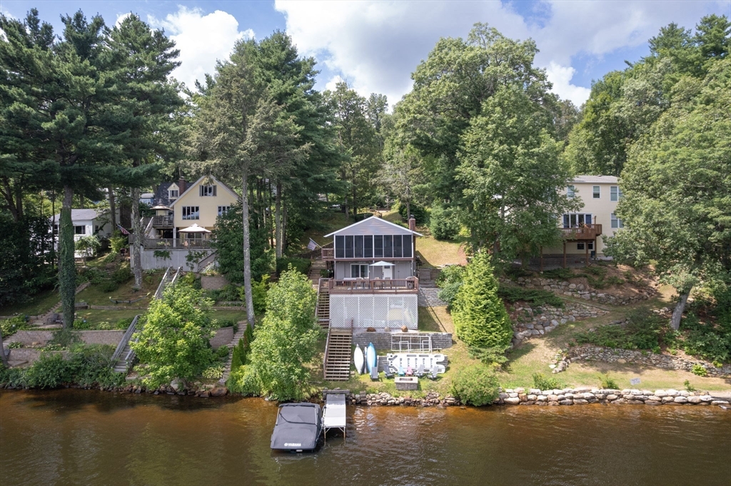 53 Sandy Beach Road Holland, MA 01521 - Photo 5 of 40 a front view of a house with a yard and lake view