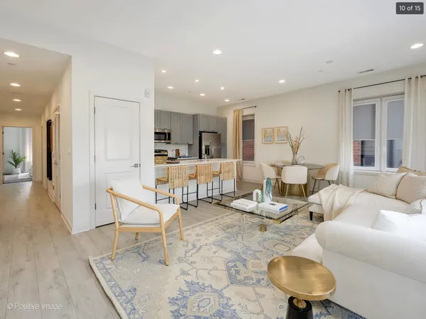 a living room with furniture and kitchen view