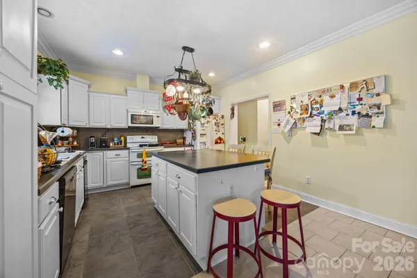 a kitchen with granite countertop a sink cabinets and window