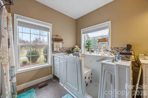 a room with sink dryer and washer