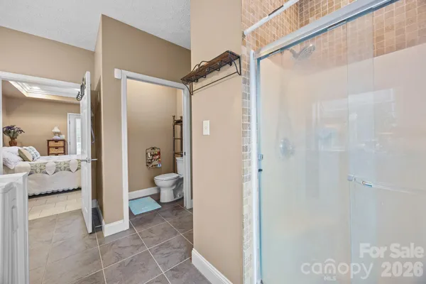 a en suite bathroom with a shower and a toilet