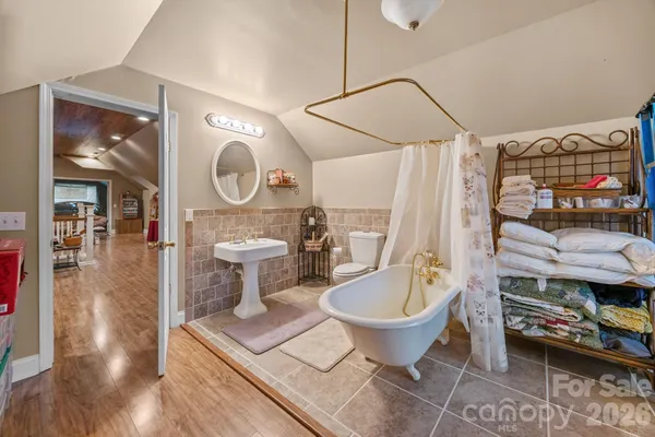 a bathroom with a toilet a sink and shower