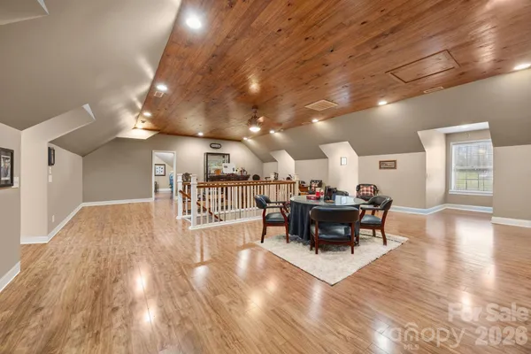 a dining room with furniture wooden floor and a rug