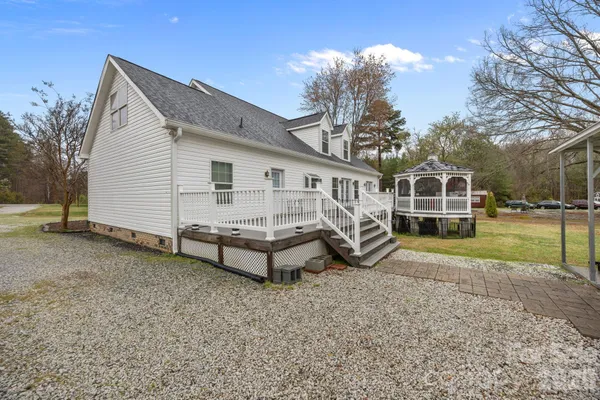 a view of a house with a yard and sitting area