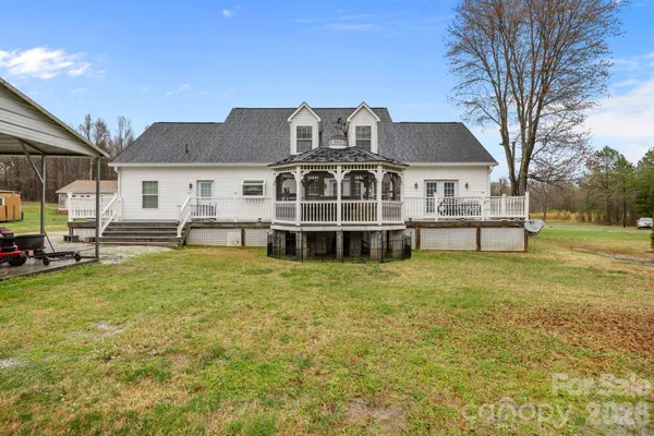 a front view of a house with a garden and deck