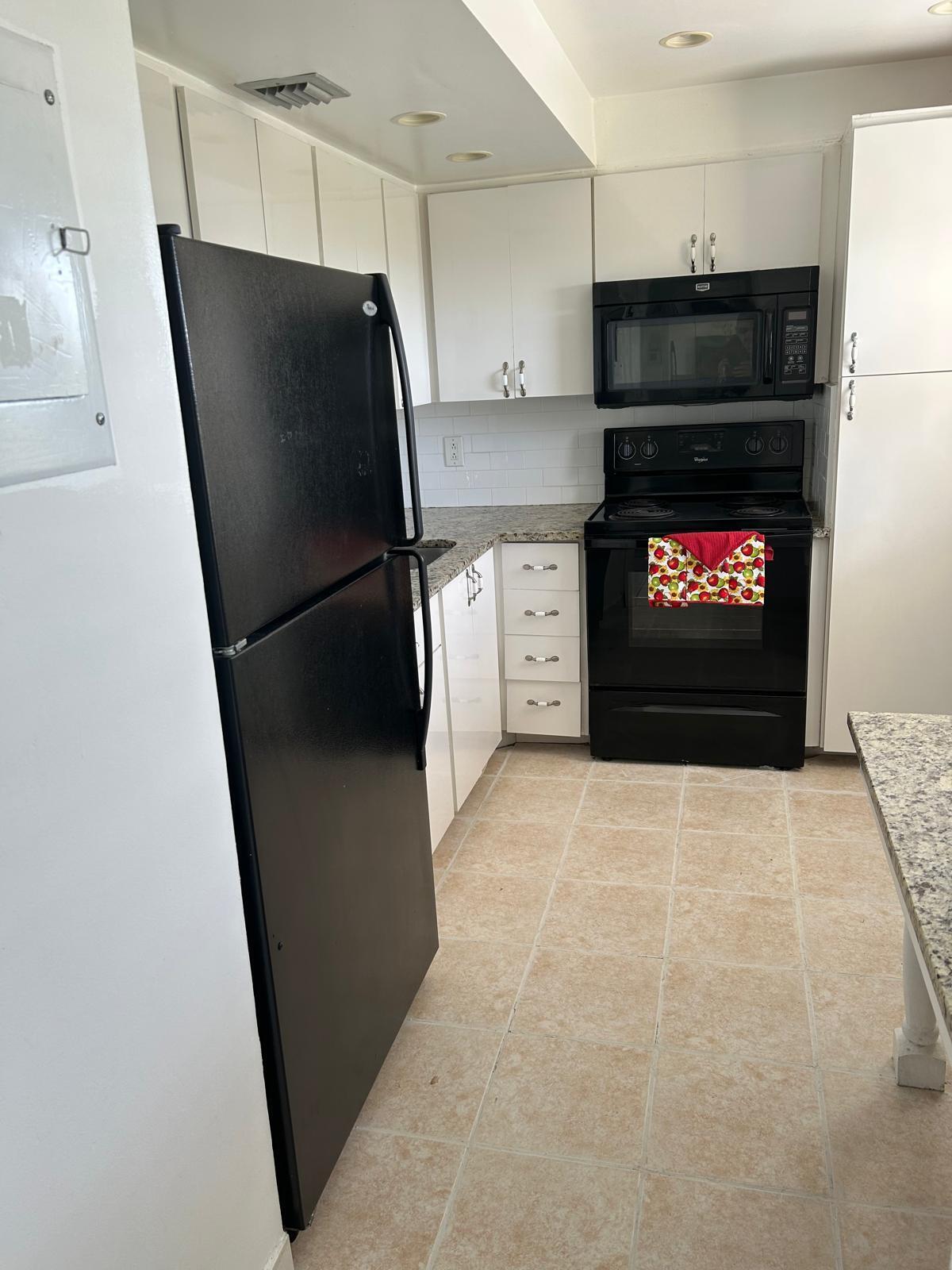 2661 South Course Drive, Unit 703 Pompano Beach, FL 33069 - Photo 11 of 11 a kitchen with stainless steel appliances a refrigerator and a stove top oven