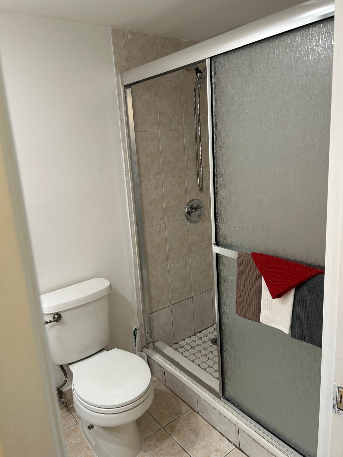 2661 South Course Drive, Unit 703 Pompano Beach, FL 33069 - Photo 2 of 11 a bathroom with a toilet and a shower