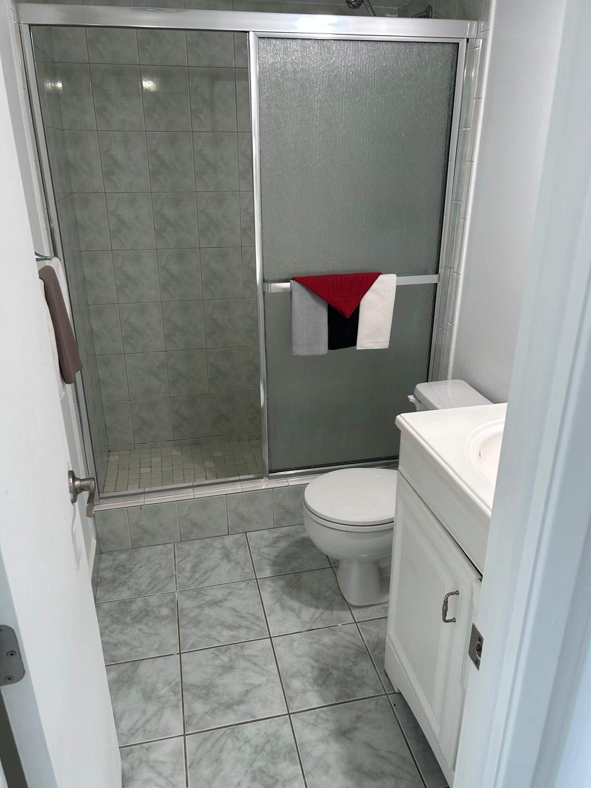 2661 South Course Drive, Unit 703 Pompano Beach, FL 33069 - Photo 6 of 11 a bathroom with a toilet and a shower