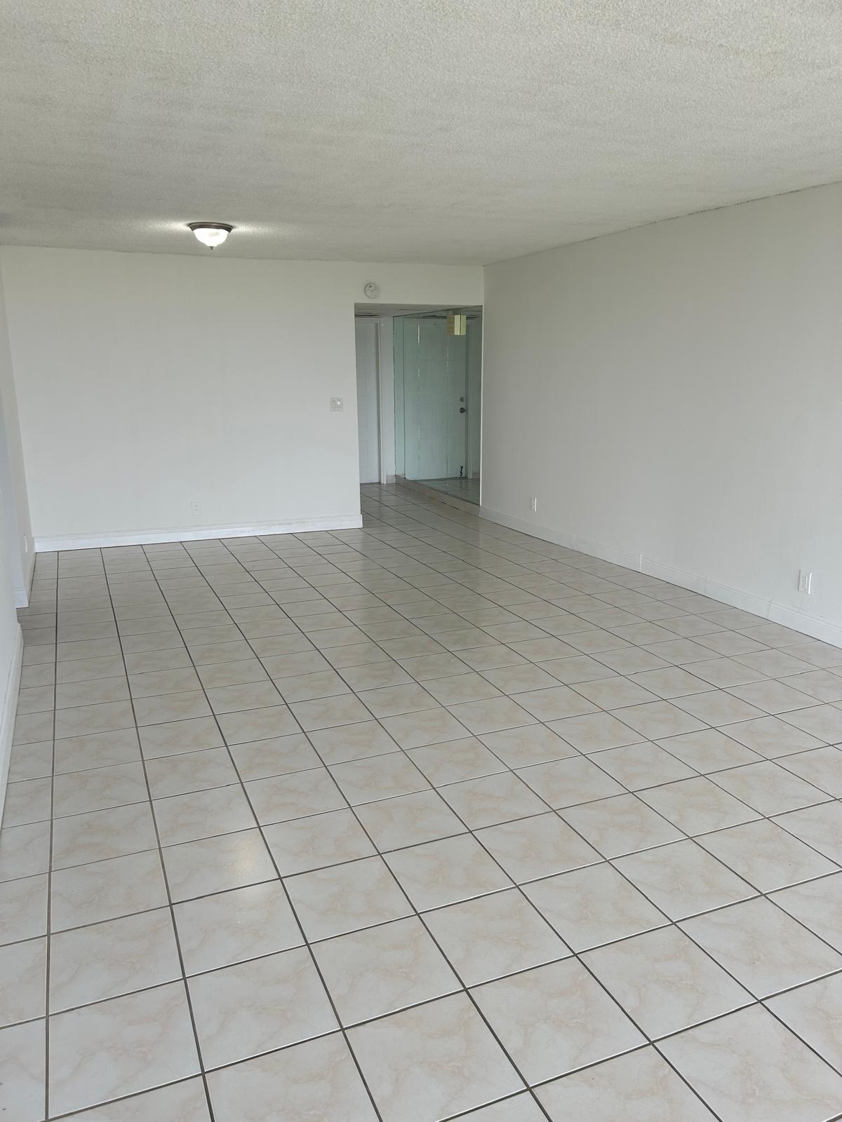 2661 South Course Drive, Unit 703 Pompano Beach, FL 33069 - Photo 7 of 11 a view of an empty room and window