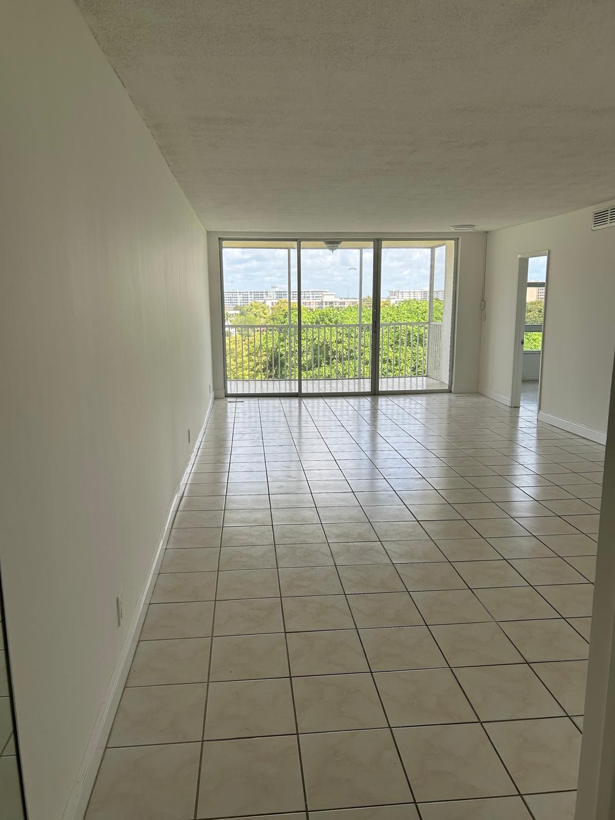 2661 South Course Drive, Unit 703 Pompano Beach, FL 33069 - Photo 10 of 11 a view of an empty room and window
