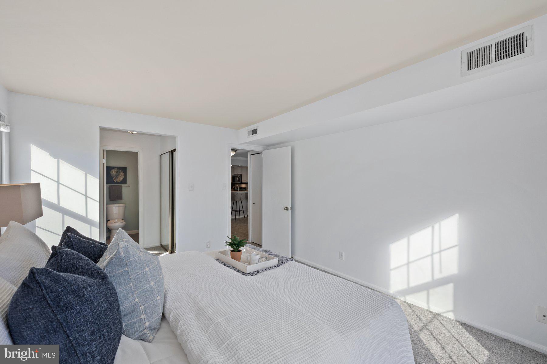 20313 Beaconfield Terrace, Unit 102 Germantown, MD 20874 - Photo 15 of 23 a bedroom with a bed and a window