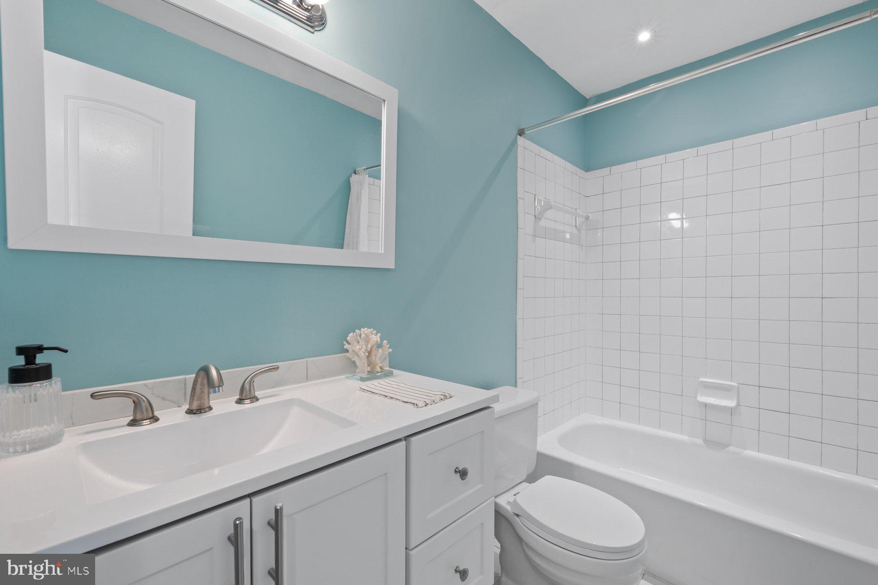 20313 Beaconfield Terrace, Unit 102 Germantown, MD 20874 - Photo 19 of 23 a bathroom with a sink toilet and shower