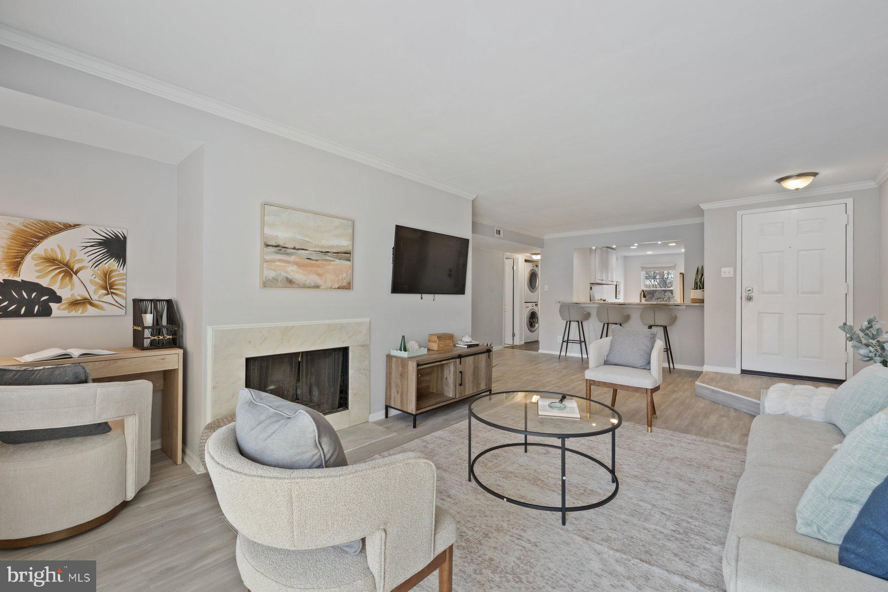 20313 Beaconfield Terrace, Unit 102 Germantown, MD 20874 - Photo 2 of 23 a living room with furniture and a fireplace