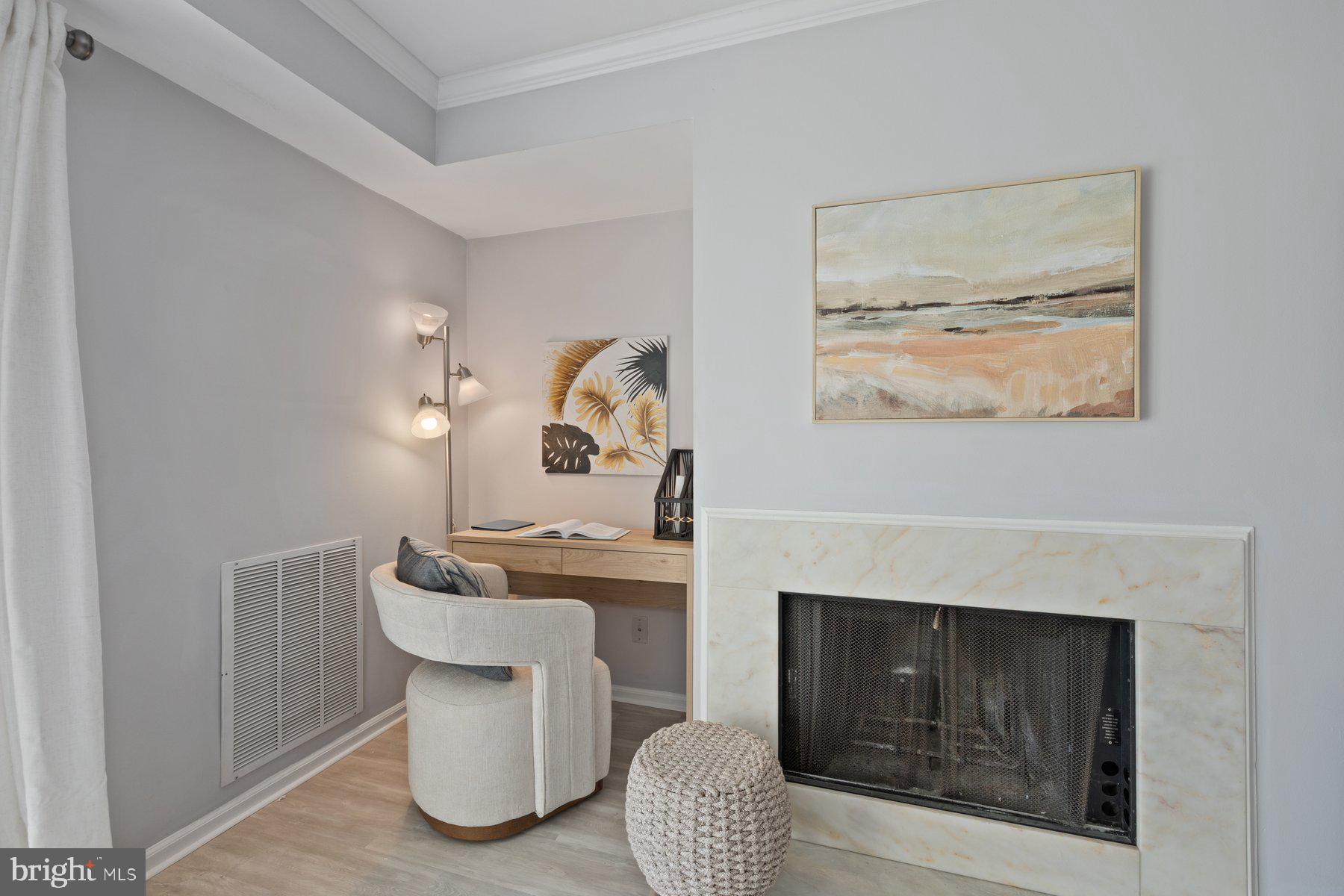 20313 Beaconfield Terrace, Unit 102 Germantown, MD 20874 - Photo 5 of 23 a living room with furniture and a fireplace