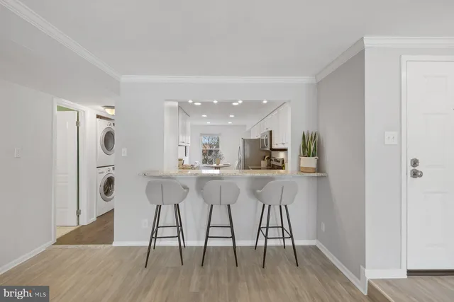 a view of kitchen with refrigerator microwave and wooden floor