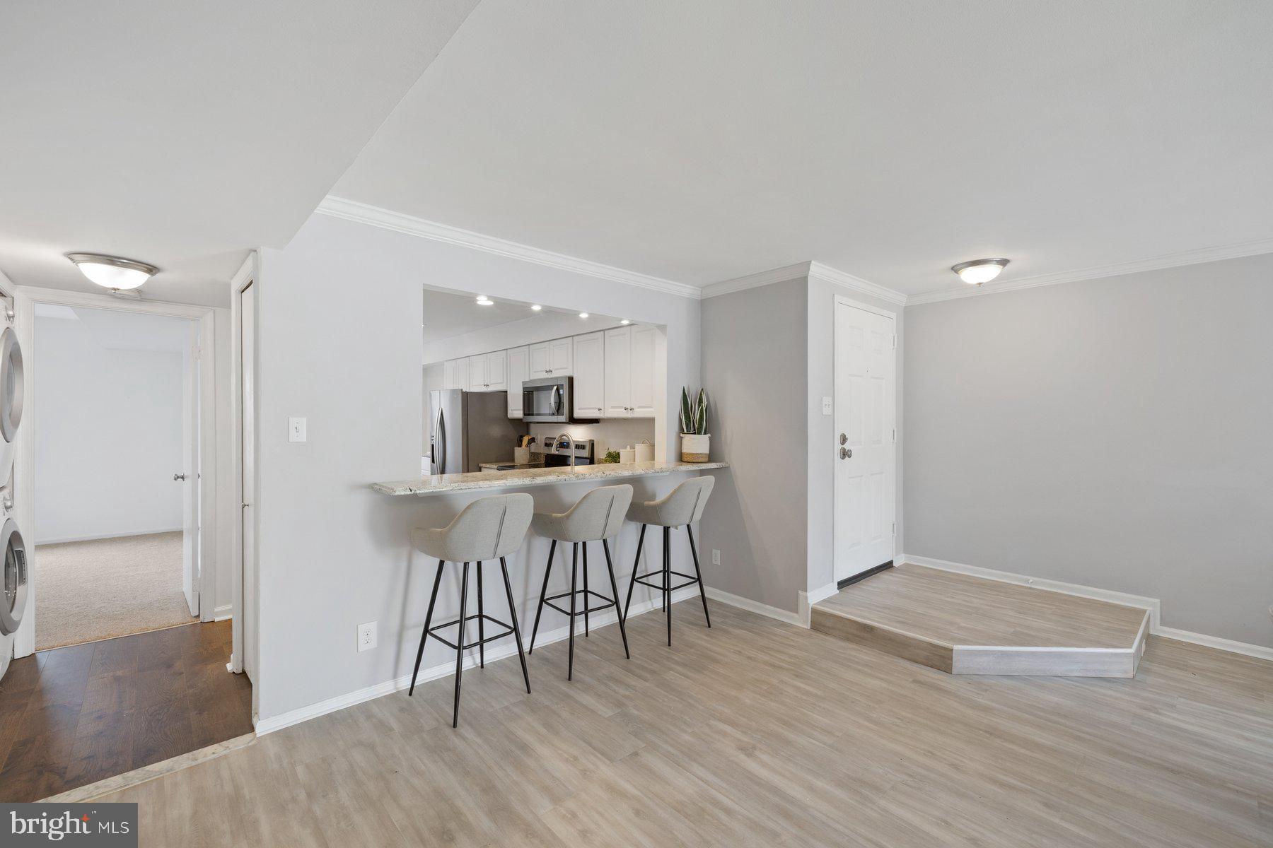 20313 Beaconfield Terrace, Unit 102 Germantown, MD 20874 - Photo 7 of 23 a view of kitchen with furniture and wooden floor