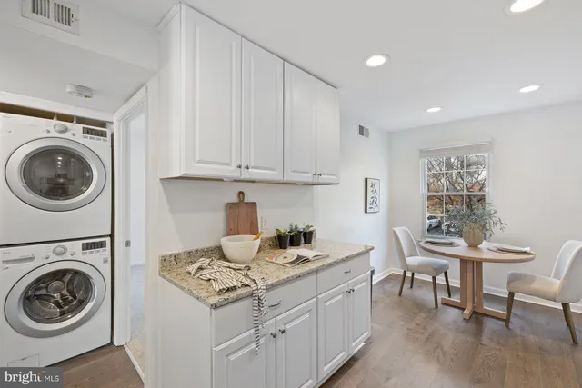 a kitchen with a stove a table and chairs in it