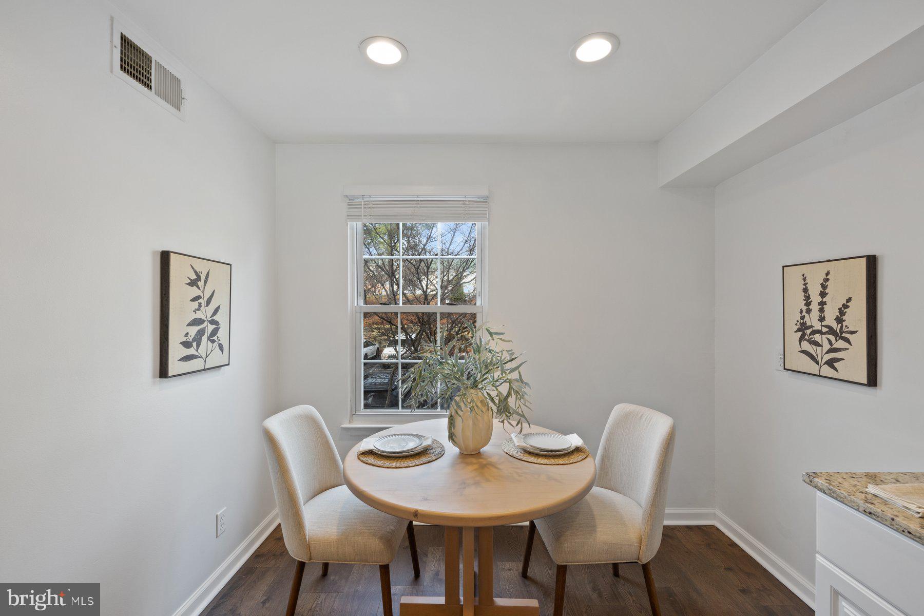 20313 Beaconfield Terrace, Unit 102 Germantown, MD 20874 - Photo 10 of 23 a view of a dining room with furniture and wooden floor