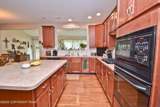 a open kitchen with stainless steel appliances granite countertop a sink and counter space
