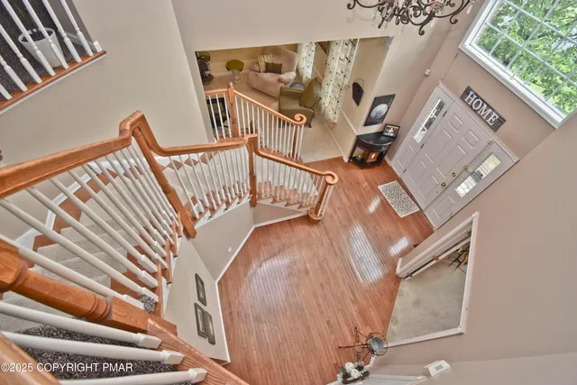 a view of staircase with wooden floor and a rug