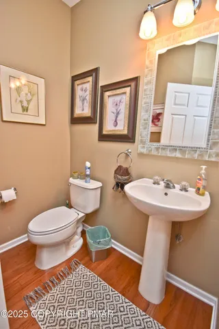 a bathroom with a sink toilet and a mirror
