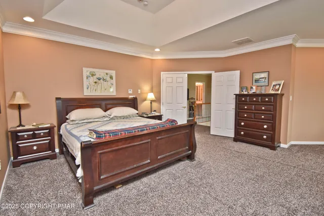 a spacious bedroom with a bed and a cabinets