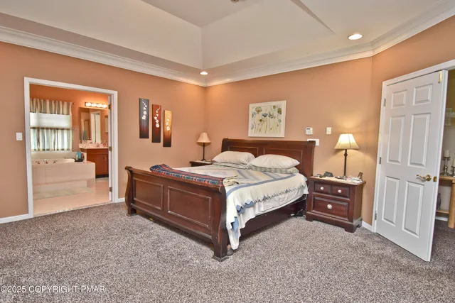 a spacious bedroom with a bed and wooden floor