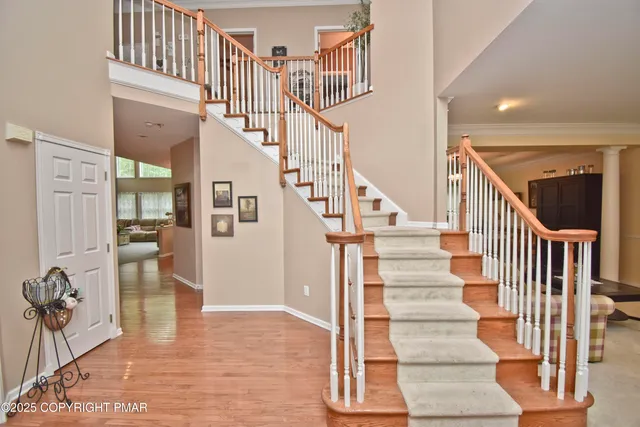 a view of staircase with lots of frames and couches