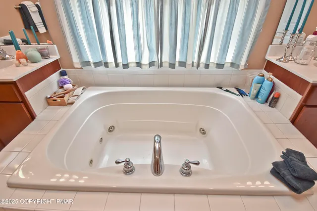 a bathroom with bathtub and window