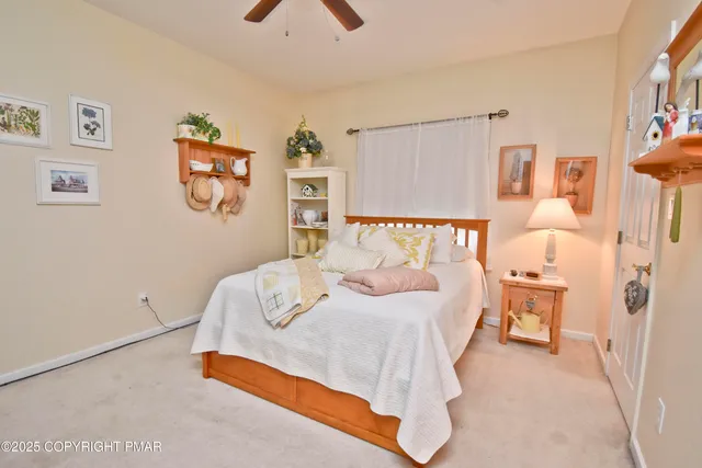 a bedroom with a bed and painting on the wall