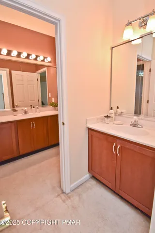 a bathroom with a double vanity sink and mirror