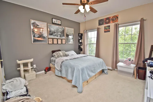 a spacious bedroom with a bed and a chandelier