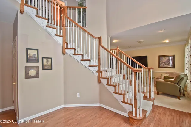 a view of entryway and hall with wooden floor