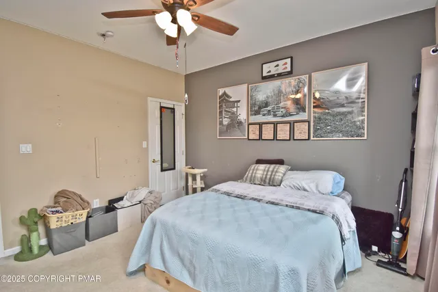 a bedroom with bed and a window