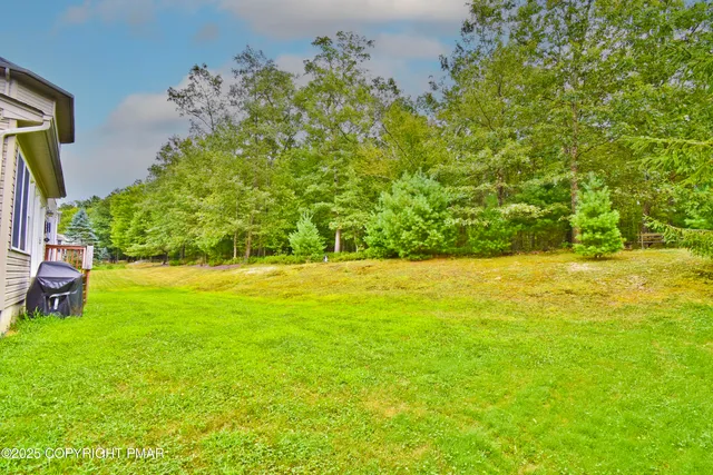 a view of yard with swimming pool