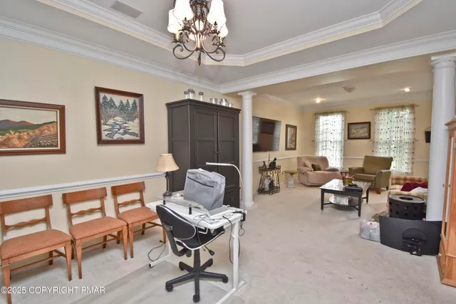 a living room with furniture windows and a chandelier