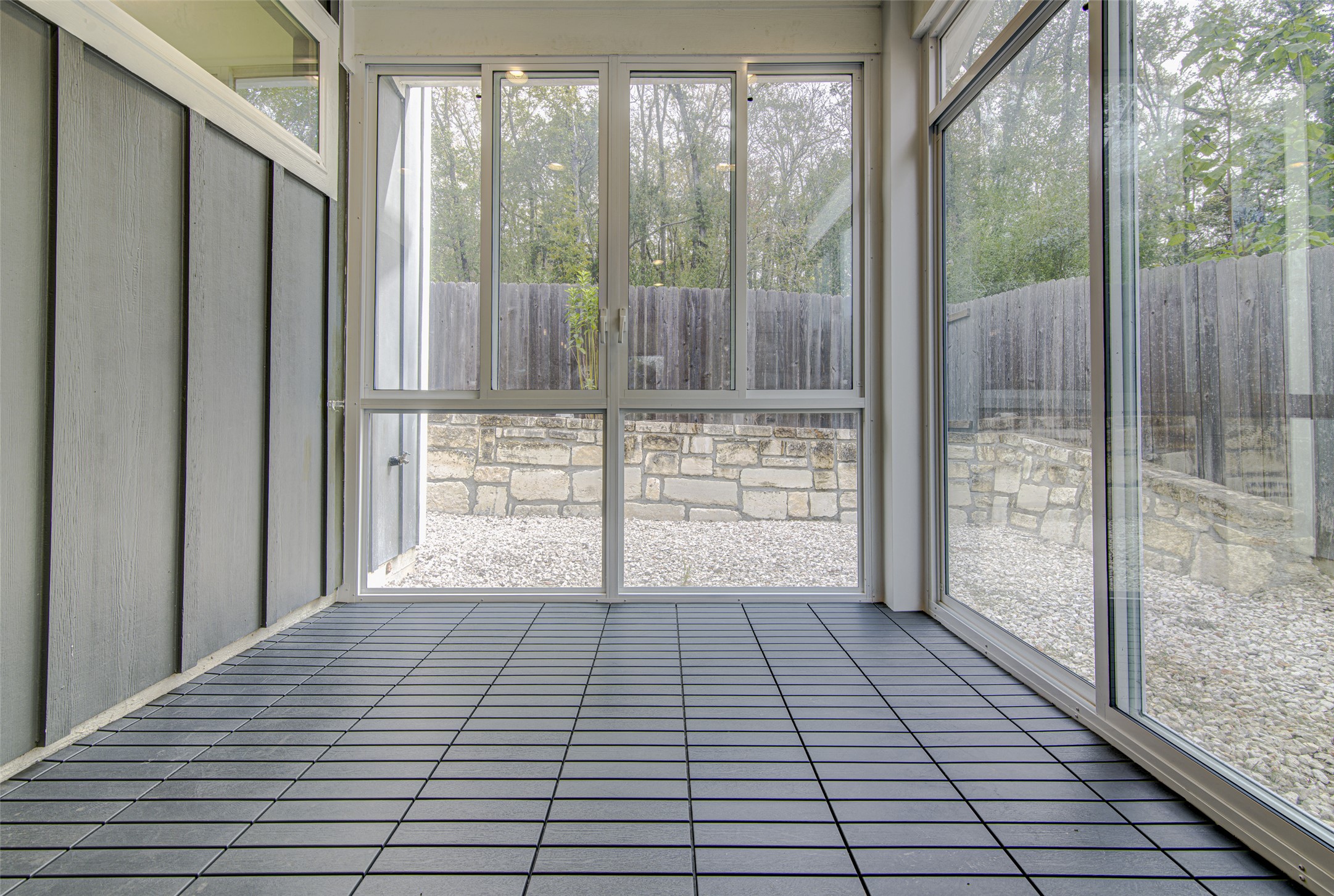 1904 Bunche Road, Unit B Austin, TX 78721 - Photo 24 of 29 Enclosed porch with floor-to-ceiling windows, a glass sliding door, and a comfortable space for relaxing or entertaining.
