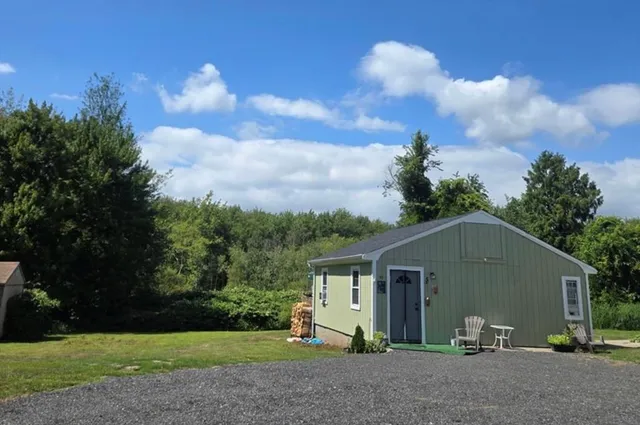 a view of a house with yard and a garden