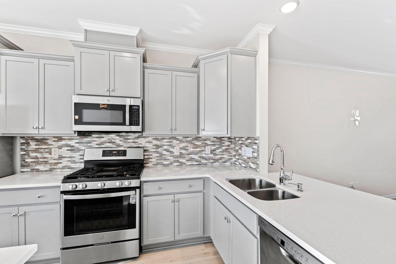 6103 Kayton Street Raleigh, NC 27616 - Photo 11 of 45 a kitchen with granite countertop a sink stove and microwave