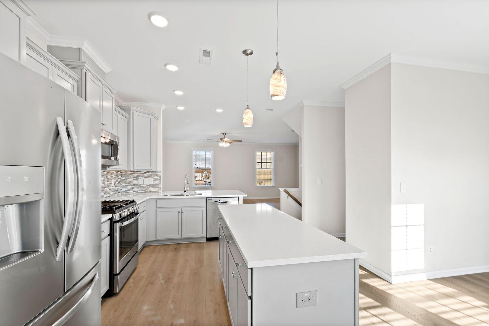 6103 Kayton Street Raleigh, NC 27616 - Photo 12 of 45 a kitchen with a sink stainless steel appliances and window