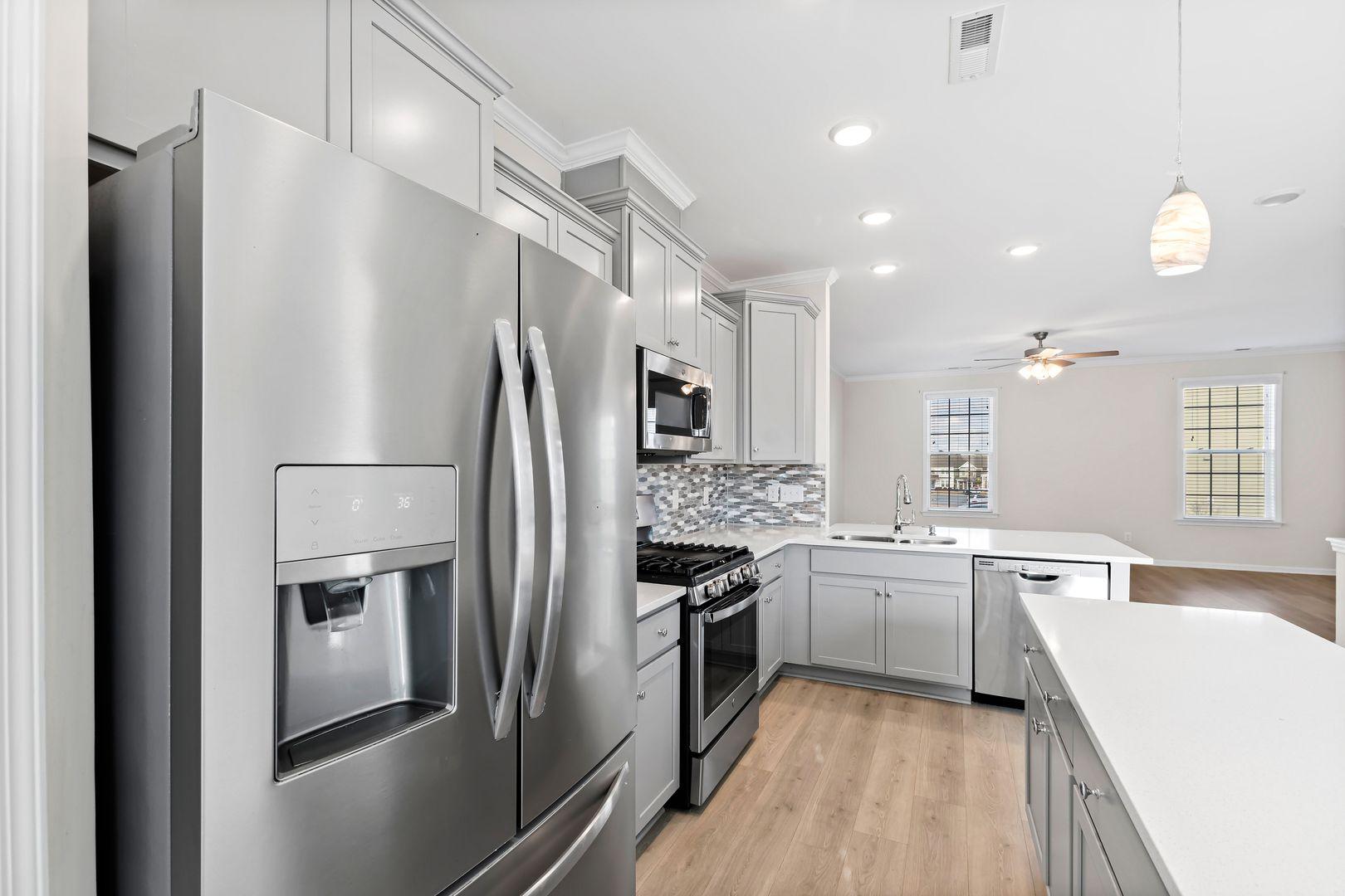 6103 Kayton Street Raleigh, NC 27616 - Photo 15 of 45 a large kitchen with a large counter top stainless steel appliances and cabinets