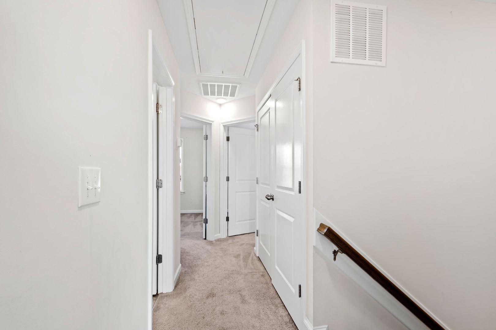 6103 Kayton Street Raleigh, NC 27616 - Photo 17 of 45 a view of a hallway with a white walls