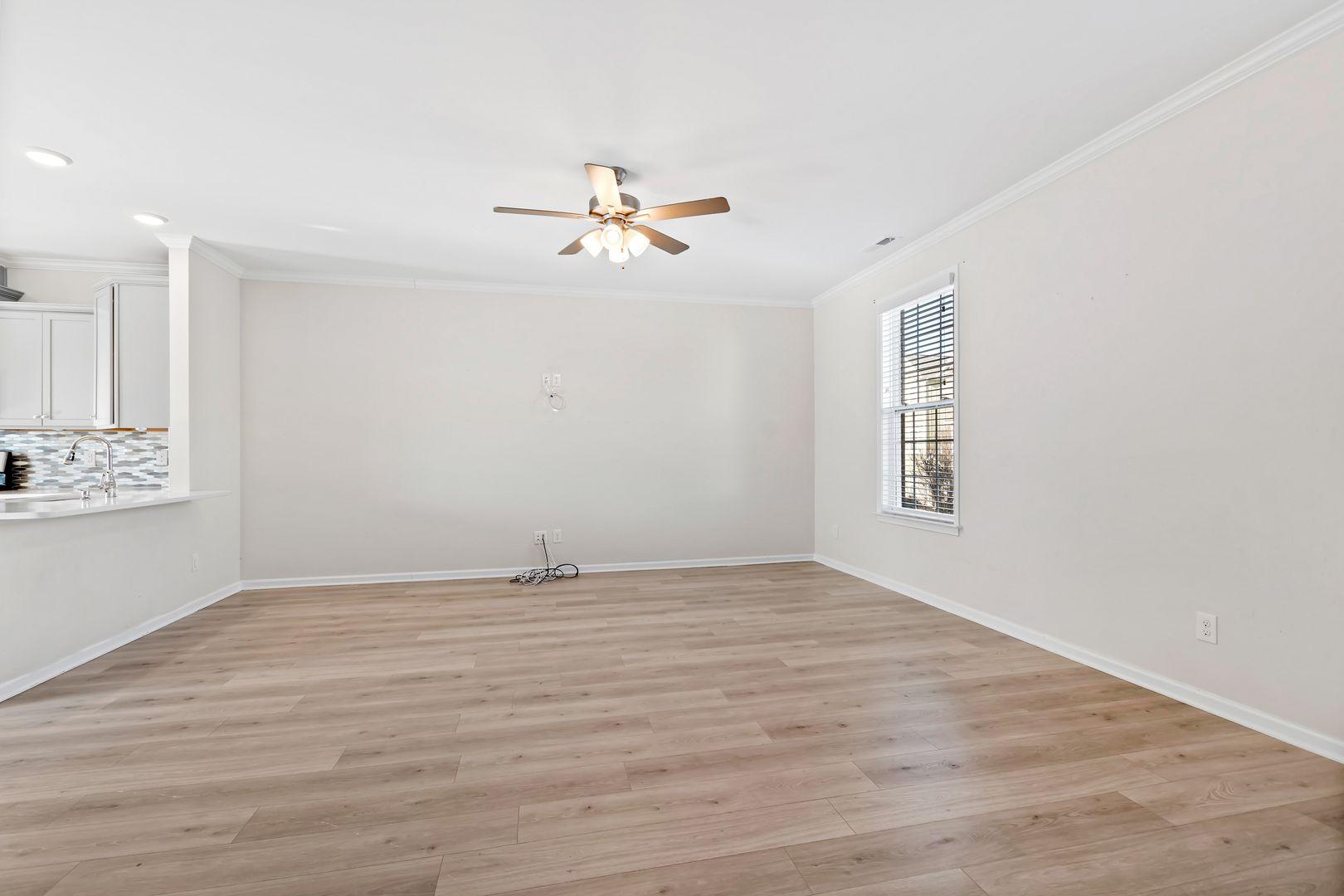 6103 Kayton Street Raleigh, NC 27616 - Photo 22 of 45 a view of a room with wooden floor and ceiling fan