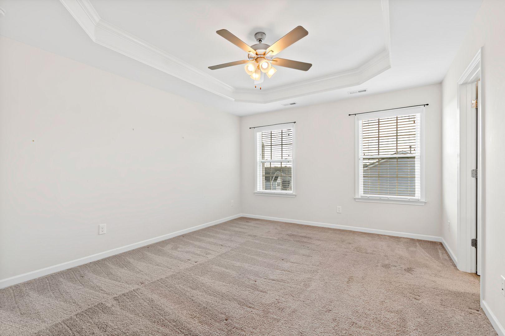6103 Kayton Street Raleigh, NC 27616 - Photo 28 of 45 an empty room with a ceiling fan and window