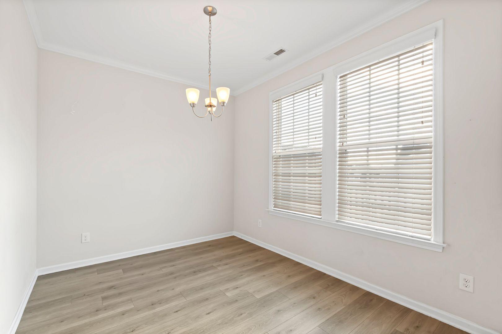 6103 Kayton Street Raleigh, NC 27616 - Photo 29 of 45 a view of an empty room with wooden floor and a window