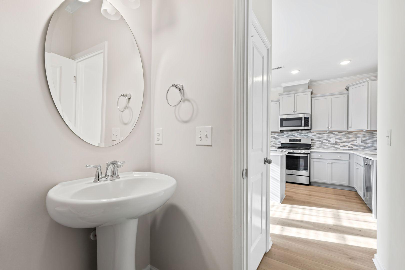 6103 Kayton Street Raleigh, NC 27616 - Photo 31 of 45 a kitchen with stainless steel appliances a sink and a refrigerator