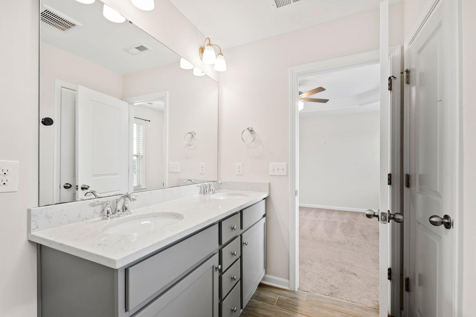 6103 Kayton Street Raleigh, NC 27616 - Photo 32 of 45 a bathroom with a sink double vanity and shower