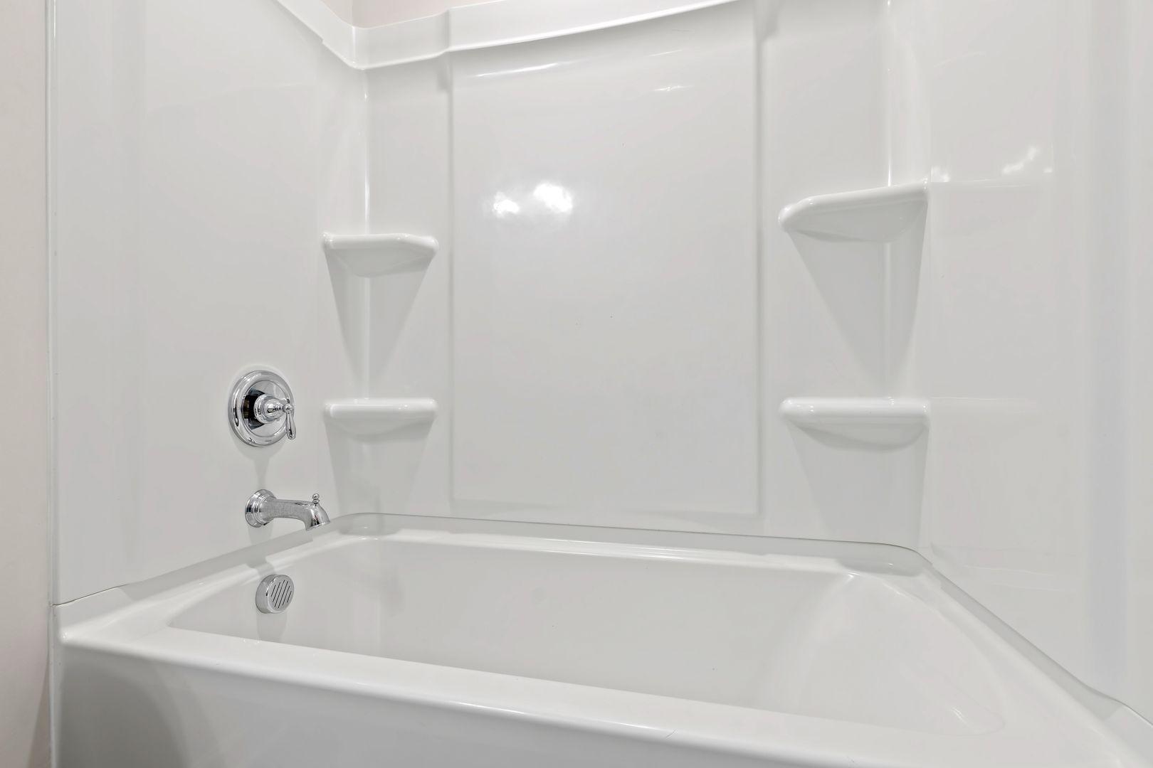 6103 Kayton Street Raleigh, NC 27616 - Photo 33 of 45 a white bath tub sitting next to a white sink