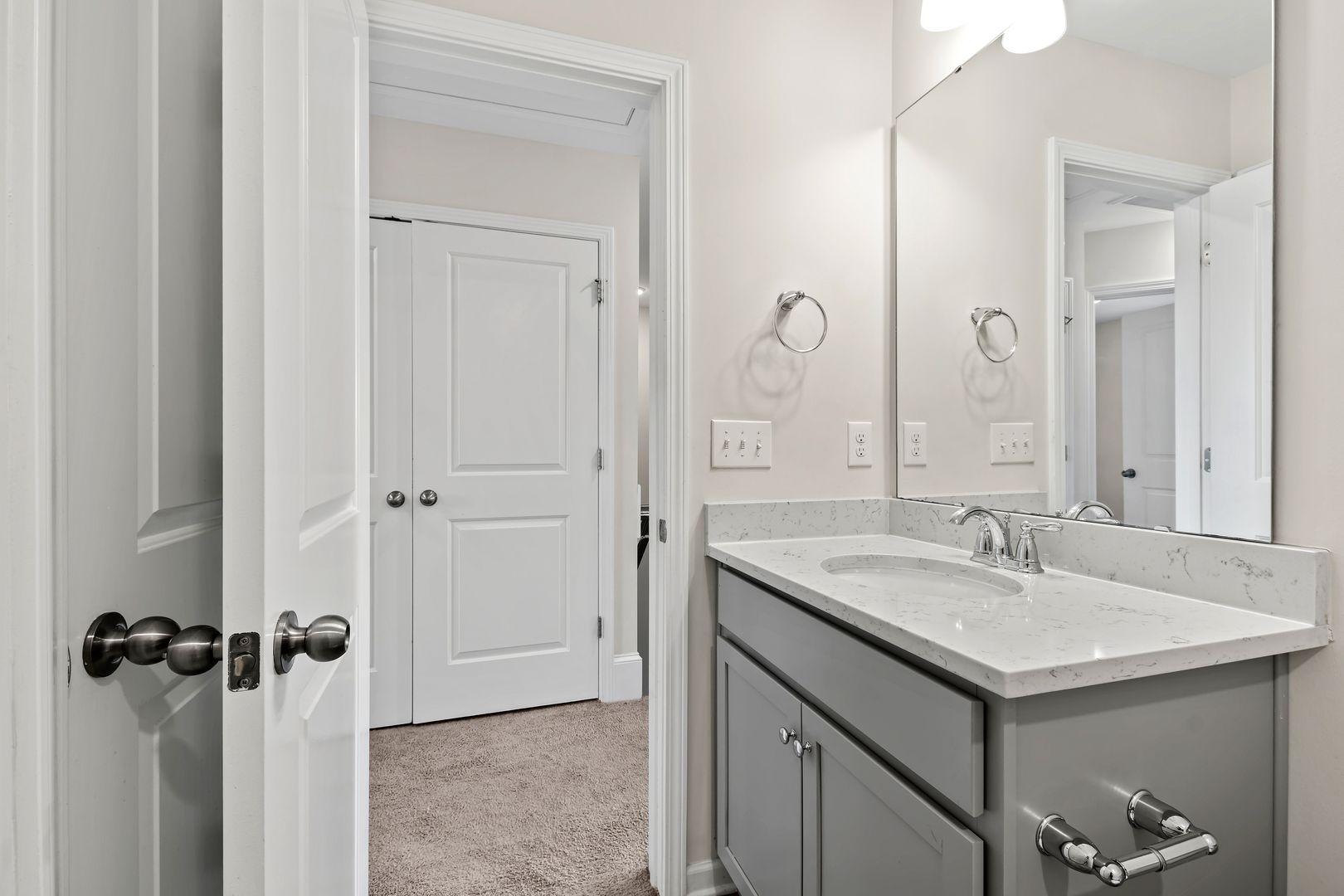 6103 Kayton Street Raleigh, NC 27616 - Photo 34 of 45 a bathroom with a sink and a mirror