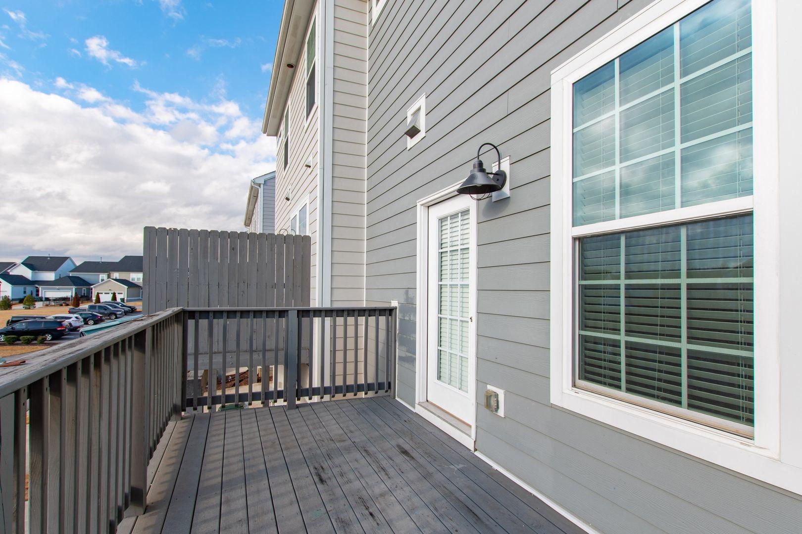 6103 Kayton Street Raleigh, NC 27616 - Photo 40 of 45 a view of a balcony with wooden floor and fence